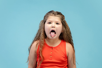 Image showing Happy caucasian little girl isolated on studio background. Looks happy, cheerful, sincere. Copyspace. Childhood, education, emotions concept