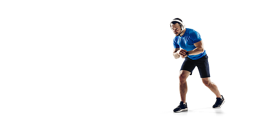 Image showing Caucasian professional male runner, athlete training isolated on white studio background. Copyspace for ad.