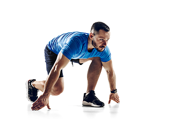 Image showing Caucasian professional male runner, athlete training isolated on white studio background. Copyspace for ad.