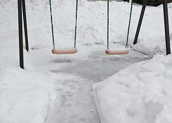 Image showing swing on the playground in the yard in winter