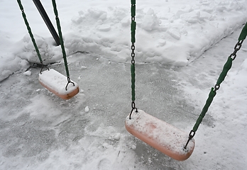 Image showing swing on the playground in the yard in winter
