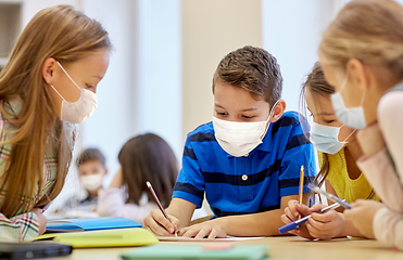 Image showing group of students in masks learning at school