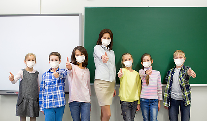 Image showing students and school teacher in mask show thumbs up