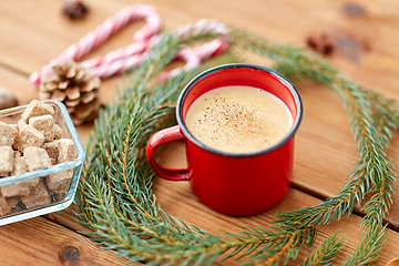 Image showing cup of eggnog, fir branches, gingerbread and sugar