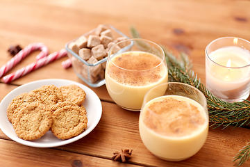 Image showing glasses of eggnog, oatmeal cookies and fir branch