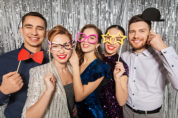 Image showing happy friends posing with party props