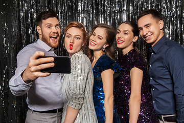 Image showing happy friends taking selfie by smartphone at party