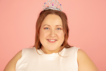 Image showing Beautiful caucasian plus size model isolated on pink studio background. Concept of inclusion, human emotions, facial expression