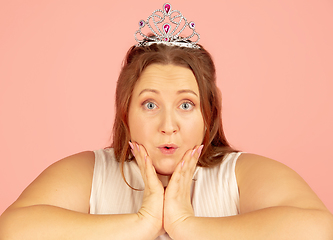 Image showing Beautiful caucasian plus size model isolated on pink studio background. Concept of inclusion, human emotions, facial expression