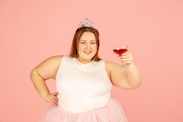 Image showing Beautiful caucasian plus size model isolated on pink studio background. Concept of inclusion, human emotions, facial expression