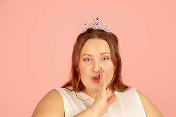 Image showing Beautiful caucasian plus size model isolated on pink studio background. Concept of inclusion, human emotions, facial expression