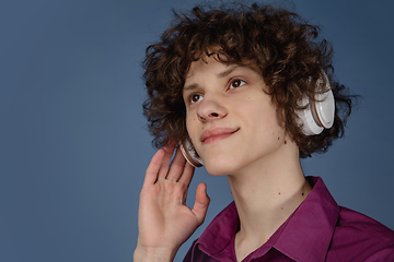 Image showing Caucasian young man\'s portrait isolated on blue studio background with copyspace