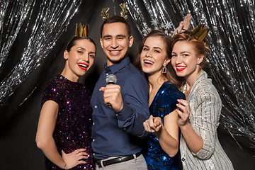 Image showing friends with microphone singing at christmas party