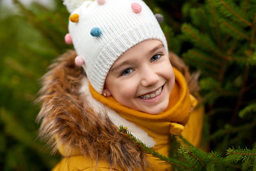 Image showing little girl choosing christmas tree at market