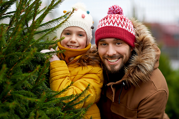 Image showing happy family choosing christmas tree at market