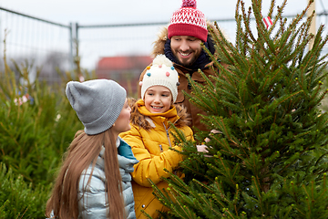 Image showing happy family choosing christmas tree at market