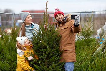 Image showing family taking selfie with christmas tree at market