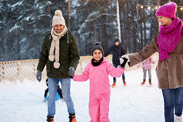 Image showing happy family at outdoor skating rink in winter