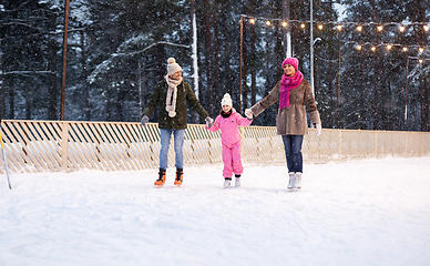 Image showing happy family at outdoor skating rink in winter