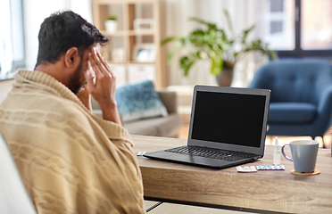 Image showing sick indian man having video call on laptop