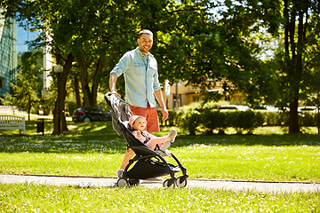 Image showing happy father with child in stroller at summer park