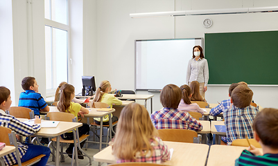 Image showing group of students with teacher in mask at school