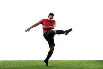 Image showing Young football, soccer player of team in action, motion isolated on white background. Concept of sport, movement, energy and dynamic.