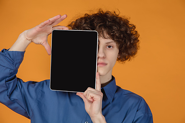 Image showing Caucasian young man\'s portrait isolated on yellow studio background with copyspace