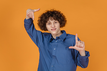 Image showing Caucasian young man\'s portrait isolated on yellow studio background with copyspace