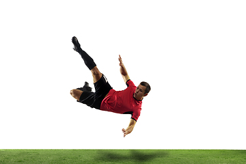 Image showing Young football, soccer player of team in action, motion isolated on white background. Concept of sport, movement, energy and dynamic.