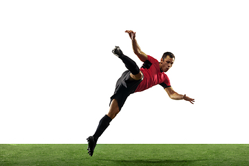 Image showing Young football, soccer player of team in action, motion isolated on white background. Concept of sport, movement, energy and dynamic.