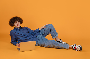 Image showing Caucasian young man\'s portrait isolated on yellow studio background with copyspace