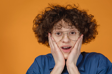 Image showing Caucasian young man\'s portrait isolated on yellow studio background with copyspace