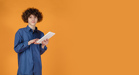 Image showing Caucasian young man\'s portrait isolated on yellow studio background with copyspace