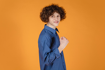 Image showing Caucasian young man\'s portrait isolated on yellow studio background with copyspace