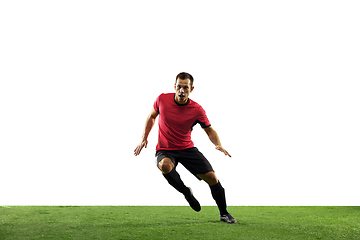 Image showing Young football, soccer player of team in action, motion isolated on white background. Concept of sport, movement, energy and dynamic.