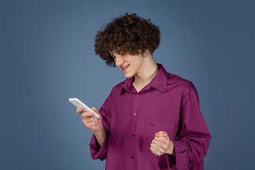 Image showing Caucasian young man\'s portrait isolated on blue studio background with copyspace