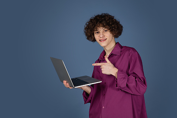 Image showing Caucasian young man\'s portrait isolated on blue studio background with copyspace