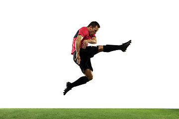 Image showing Young football, soccer player of team in action, motion isolated on white background. Concept of sport, movement, energy and dynamic.
