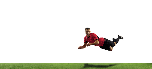 Image showing Young football, soccer player of team in action, motion isolated on white background. Concept of sport, movement, energy and dynamic.