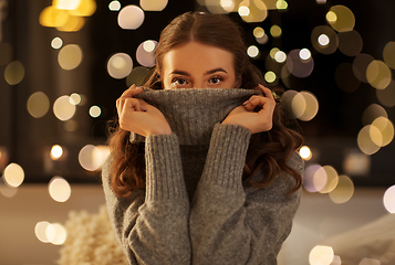 Image showing young woman in woolen sweater at night