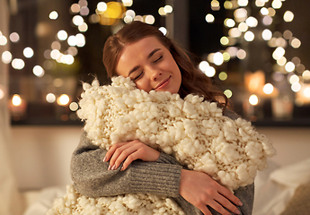 Image showing happy young woman with soft pillow in bed at home