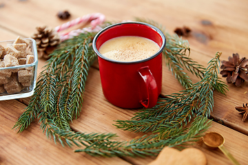 Image showing red cup of eggnog, fir branches and sugar