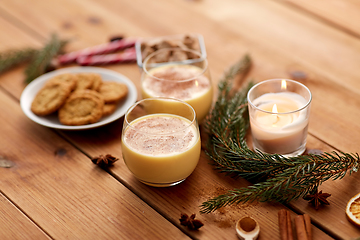 Image showing glasses of eggnog, oatmeal cookies and fir branch