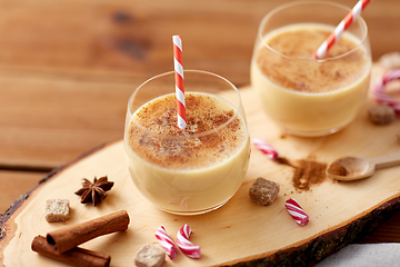 Image showing glasses of eggnog, ingredients and spices on wood