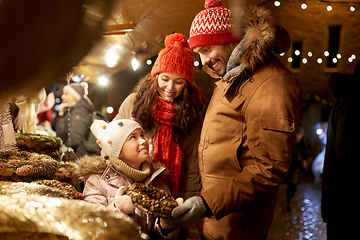 Image showing happy family buing wreath at christmas market
