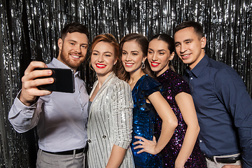 Image showing happy friends taking selfie by smartphone at party