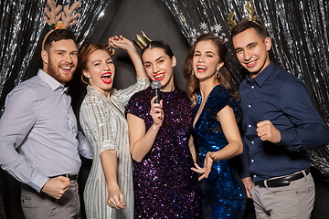 Image showing friends with microphone singing at christmas party