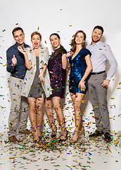 Image showing happy friends at party under confetti over white