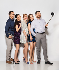 Image showing happy friends taking selfie by smartphone at party